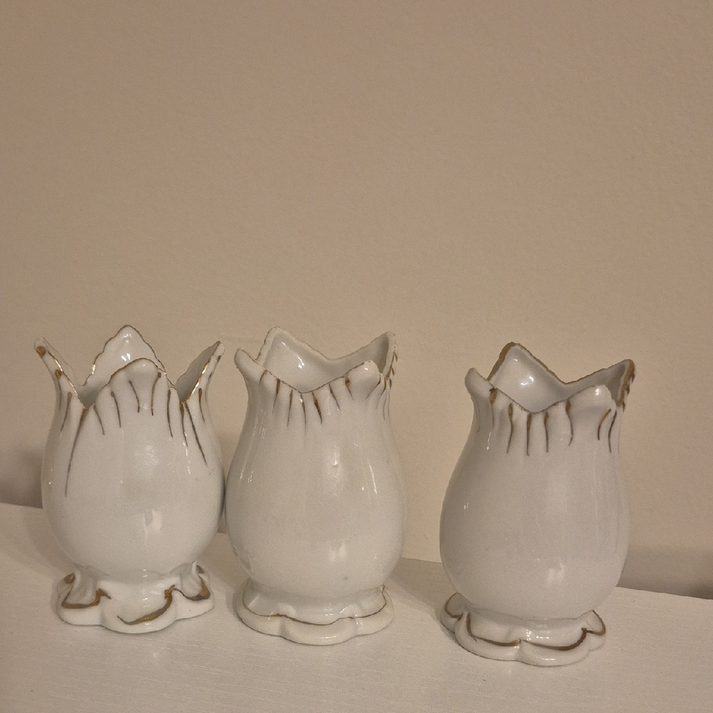 Vintage white porcelain mini vase with gold tone trim, possibly in a tulip shape